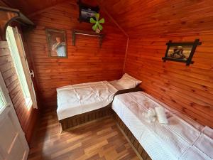 a room with two beds in a log cabin at Sweet horses HH1 in Didim