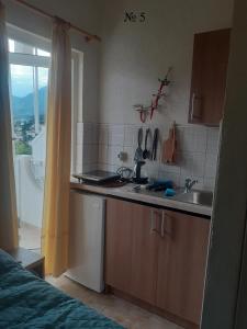 a kitchen with a sink and a counter top at OLGA apartmani in Sutomore
