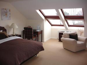 a bedroom with a bed and a chair and a desk at The Park Hotel in Dunoon