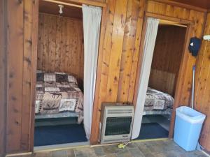 a bedroom with a bed and a television in it at cabin 2 in Steuben