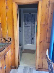 an open door to a bathroom with a toilet at cabin 2 in Manistique