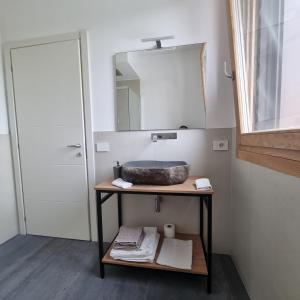 a bathroom with a sink and a mirror at Corte Bottura agriturismo in Castelnuovo del Garda +22 photos