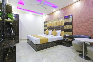 a hotel room with a bed and a table at Hotel Grand LA CASA Near IGI airport in New Delhi