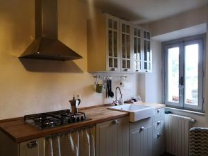 a kitchen with a sink and a stove top oven at il Borgo in Capolona