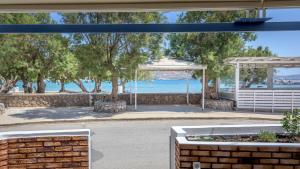 a view of the water from the patio of a house at Armenakishouses in Pollonia