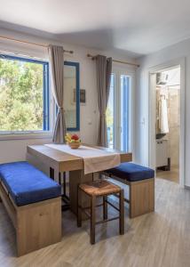 a dining room with a table and blue seats at Armenakishouses in Pollonia