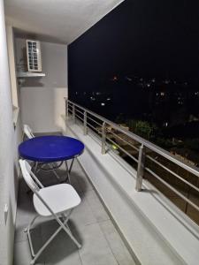 a table and a chair on a balcony with a view at PETKOV5KI.LuxuryApartments in Skopje