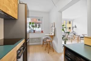 a kitchen with a counter and a dining room at Great central apartment walking distance to metro in Copenhagen