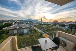 a balcony with a table and chairs and a view at Inada Rooms Ksamil in Ksamil