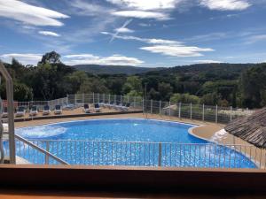 a view of a swimming pool from a balcony at Mobil-home Parc Montana Gassin in Gassin