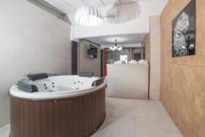 a large bathroom with a jacuzzi tub at L'Otelet By Sweet in Valencia