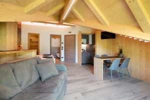 a living room and kitchen with a couch and a table at Agriturismo Bosco d'oro 5 in Livigno