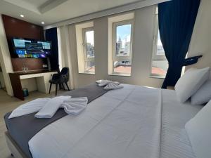 a bedroom with a large bed with two towels on it at Genoa Port Hotel in Istanbul