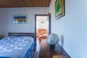 a bedroom with a bed and a bust on a table at Apartment Galjanić in Buzdohanj