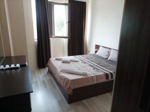 a bedroom with a bed with a window and a mirror at One Bedroom Apartment 10 - Vasil Aprilov 64 Plovdiv in Plovdiv