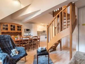 a living room with a staircase and a dining room at Appartement cosy 6 personnes avec parking à Saint-Lary - FR-1-296-382 in Saint-Lary-Soulan