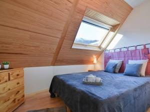 a bedroom with a large bed with a window at Appartement cosy 6 personnes avec parking à Saint-Lary - FR-1-296-382 in Saint-Lary-Soulan