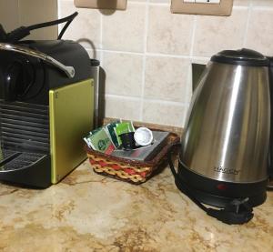 a tea kettle and a toaster on a kitchen counter at A Casa di Marzia in Rapolano Terme