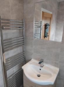 a bathroom with a sink and a mirror at Oakworth in Oakworth