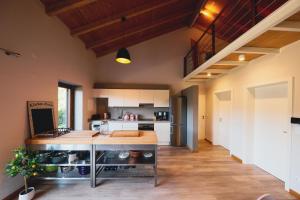 an open kitchen with a island in the middle at Salthouse Portugal - Stylish Duplex Apartment in Aljezur