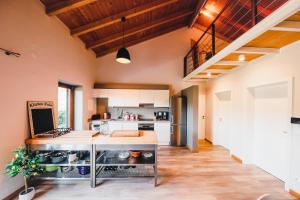 an open kitchen with a large island in the middle at Salthouse Portugal - Stylish Duplex Apartment in Aljezur