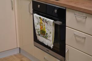 a towel hanging on the oven door of a kitchen at City Center Apartment in Burgas