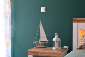 a toy sailboat on a table in a bedroom at City Center Apartment in Burgas