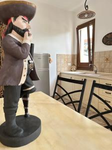 a statue of a man standing on a table in a kitchen at Baglio Mazzara in Custonaci