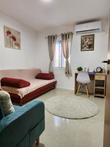 a living room with a bed and a couch at Краткосрочная посуточная аренда Бат-Ям! in Bat Yam