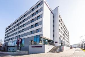 a large white building with a staircase in front of it at Premier Inn Nürnberg City Nordost in Nuremberg