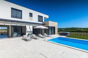 a swimming pool in the backyard of a house at Villa Chiara by SeeAdria Agency in Brtonigla