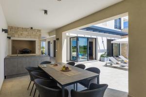 a kitchen and dining room with a table and chairs at Villa Chiara by SeeAdria Agency in Brtonigla