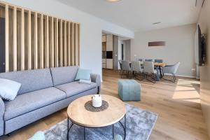 a living room with a blue couch and a table at Villa Chiara by SeeAdria Agency in Brtonigla