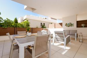 a dining room with a table and chairs at Jardinana - apartment with two bedrooms close to beach and town center in La Cala de Mijas