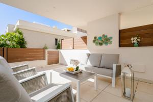 a living room with a table and chairs at Jardinana - apartment with two bedrooms close to beach and town center in La Cala de Mijas