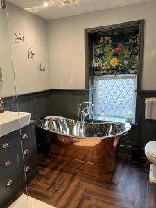 a bathroom with a large tub in the middle at Cosy Village House in Waddington