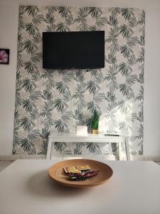 a wooden plate on a table in front of a wall at FamilyConfort Saidia in Saïdia