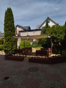 a group of benches in front of a building at Karolinka Łeba in Łeba