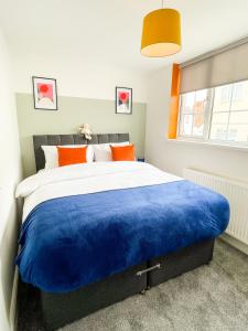 a bedroom with a large bed with a blue blanket at The New Found Lamb in Cleethorpes