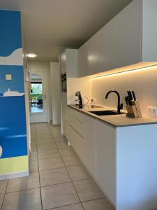 a kitchen with a sink and a counter top at Studio Blanchard in Koksijde