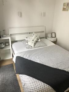 a bedroom with a white bed with pillows on it at Tiny Haus Liederbach in Alsfeld
