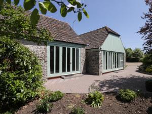 a house with large windows and a patio at Swallow Barns in Bristol