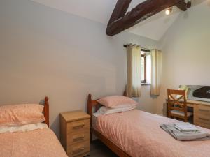a bedroom with two beds and a desk at Swallow Barns in Bristol