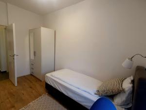 a small bedroom with a bed and a closet at Nice 2 bedroom apartment near city center in Rijeka