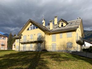 una gran casa amarilla con un gran patio en Mansarda Bucaneve, en Craveggia