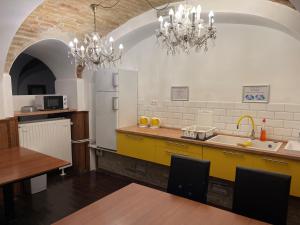 a kitchen with a sink and a refrigerator and a table at MP Hostel Budapest in Budapest