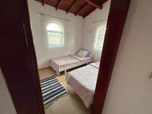 a room with two beds and two windows at sweet horses ST6 in Didim