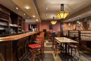 a bar with tables and chairs in a restaurant at Travelodge by Wyndham Simcoe in Simcoe