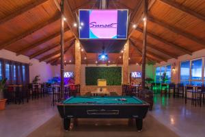 a pool table in a room with a sign on the ceiling at Djerba Holiday Beach in Midoun