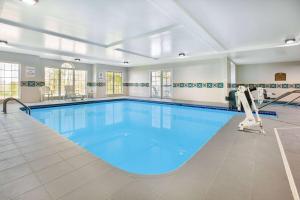 a large swimming pool with blue water at Microtel Inn by Wyndham Beckley in Beckley